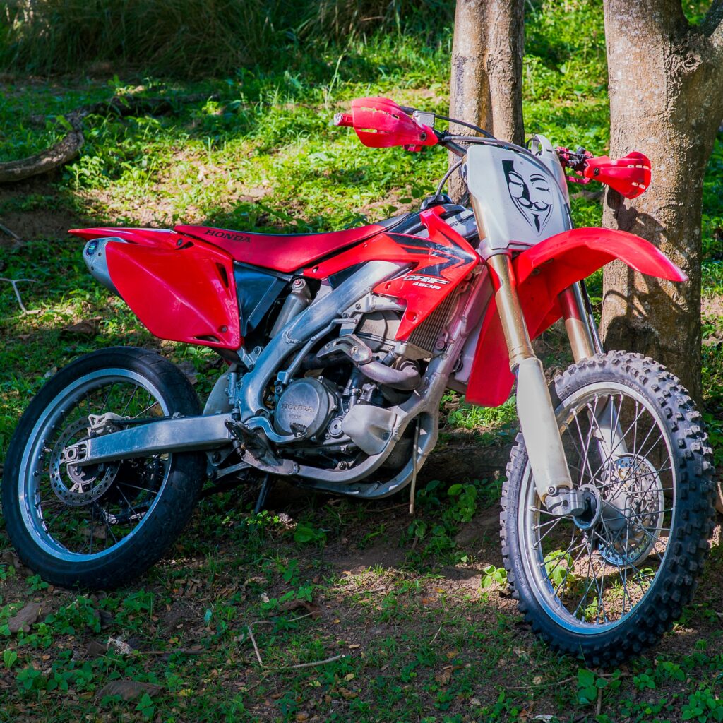 Dirt bike rider on a rainforest trail